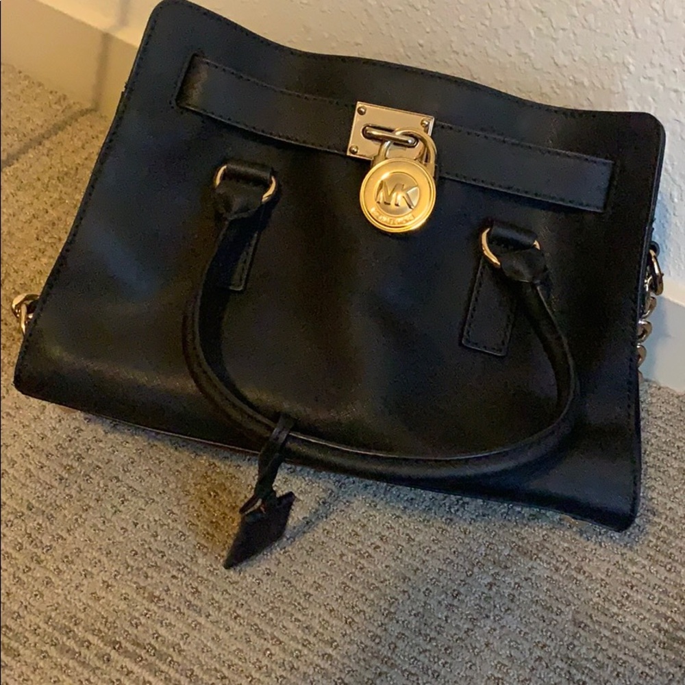Black leather MK purse, with gold logo emblem